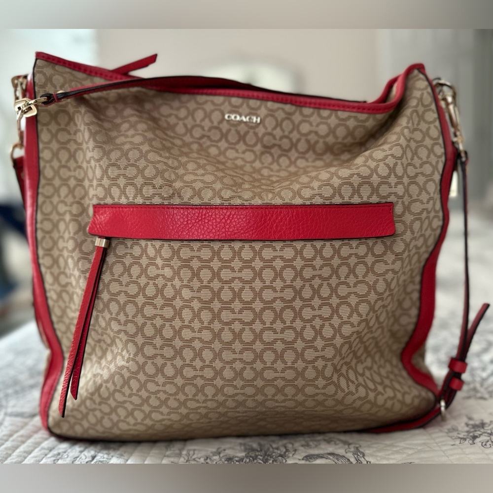 Coach light brown canvass crossbody bag with orange leather trims, front pocket